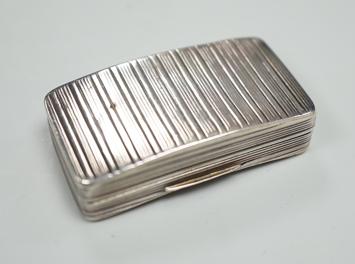 A George III ribbed silver snuff box, maker ?S, Birmingham, 1810, 58mm.